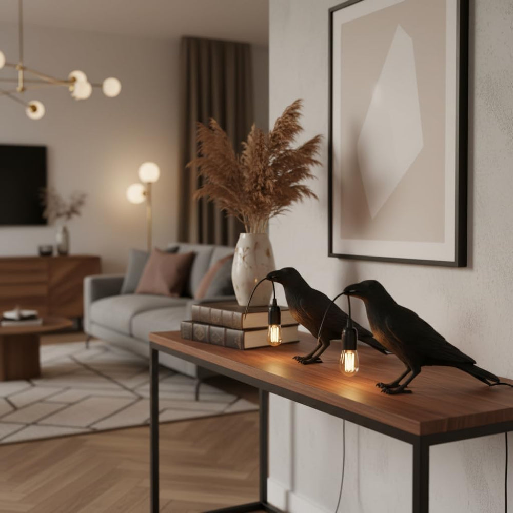 Raven table lamp on a bookshelf creating warm ambient light