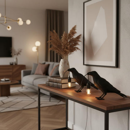 Raven table lamp on a bookshelf creating warm ambient light