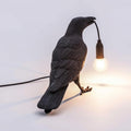 Resin crow bird lamp in black finish on a plain white background