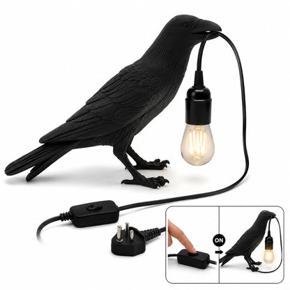 Resin raven lamp on a living room side table beside a sofa