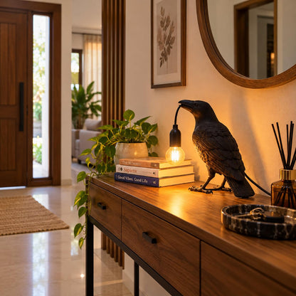 Side profile of resin raven table lamp showing detailed feathers
