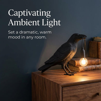 Black bird desk lamp in a home office next to a laptop
