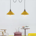 2-head spider light with yellow shades in a living room