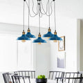 Light blue spider pendant light hanging above a dining table
